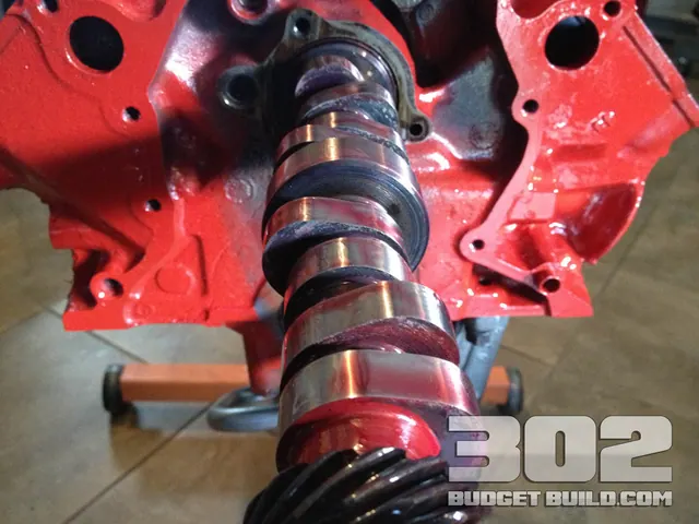The Ford Racing E303 camshaft sliding into the red block